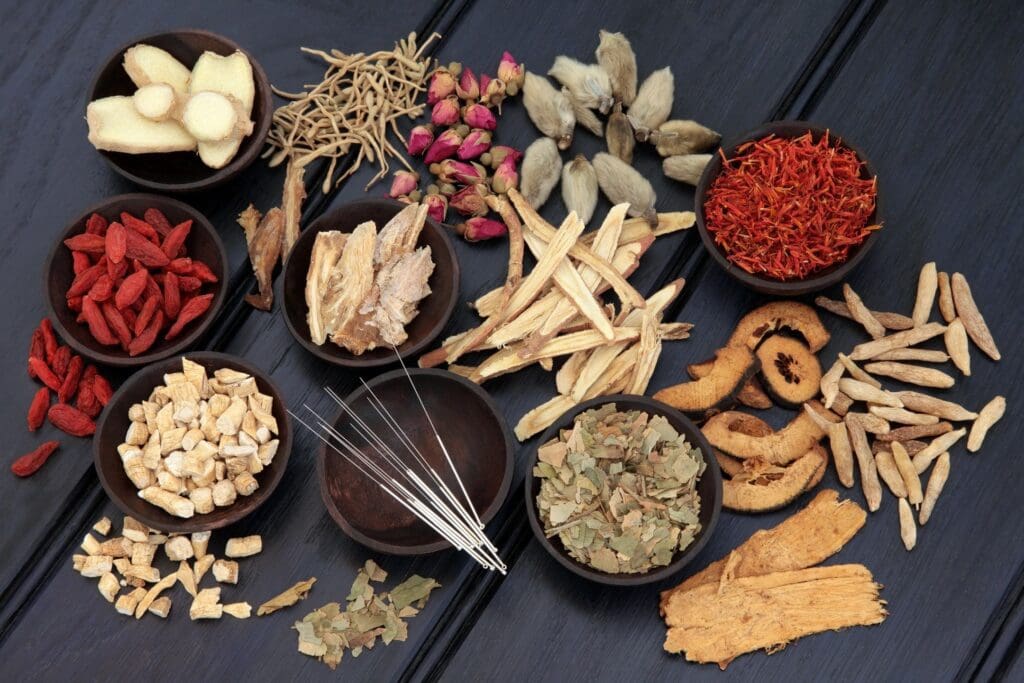 Various dried herbs and spices in wooden bowls.