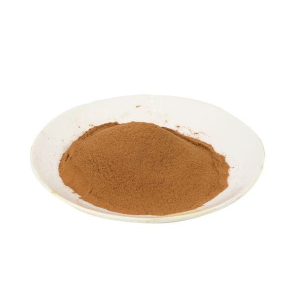 A white plate of loose cinnamon powder.